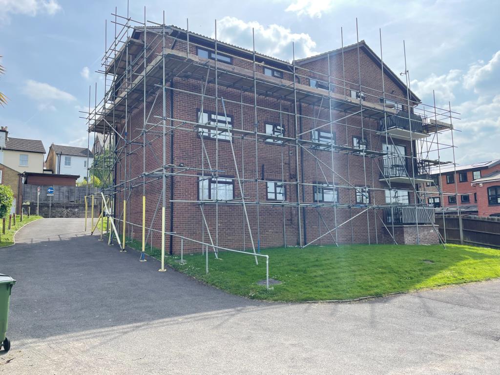 Lot: 151 - TWO-BEDROOM FLAT WITH PARKING - view of rear elevation showing driveway from parking area